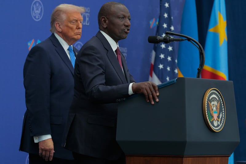 President Donald Trump listens as Kenyan President William Ruto delivers remarks during a peace accord signing ceremony between Rwandan President Paul Kagame and Democratic Republic of Congo President Felix Tshisekedi at the Donald J. Trump Institute of Peace on December 04, 2025 in Washington, DC.