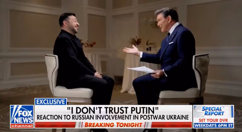 Volodymyr Zelensky laughs with Brett Baier during an interview on Fox News.