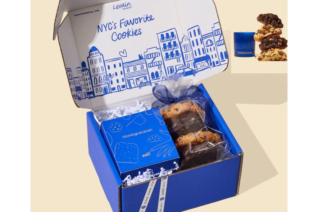 A box with cookies and a boxed candle, and another image of the box contents in the upper right corner.