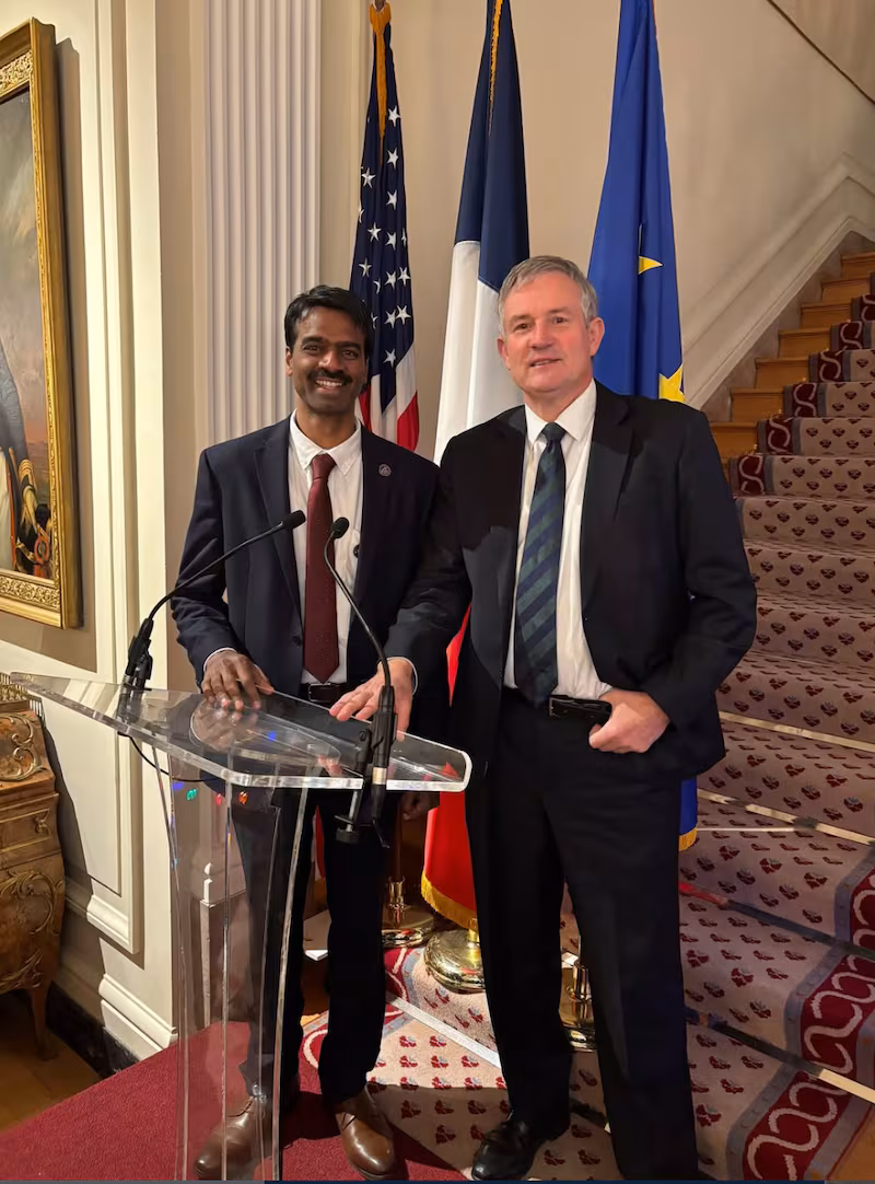 The acting director was socializing at a holiday reception on Saturday with the French ambassador, Laurent Bili.