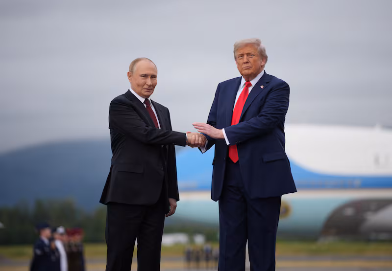 ANCHORAGE, ALASKA - AUGUST 15: U.S. President Donald Trump (R) greets Russian President Vladimir Putin as he arrives at Joint Base Elmendorf-Richardson on August 15, 2025 in Anchorage, Alaska. The two leaders are meeting for peace talks aimed at ending the war in Ukraine.  (Photo by Andrew Harnik/Getty Images)