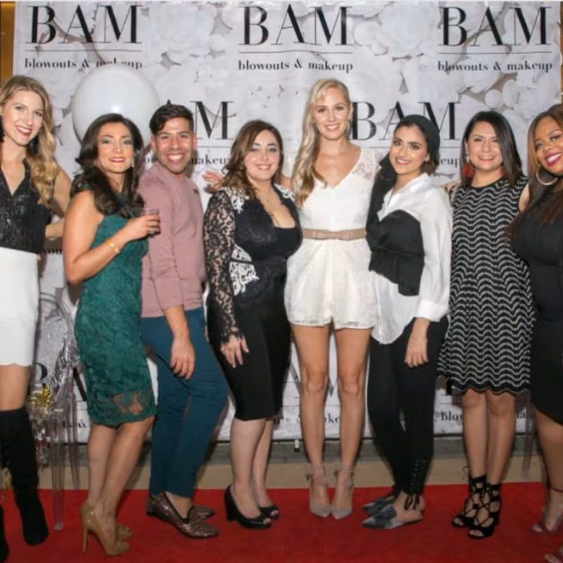 Mora Namdar, centre in black, photographed with her beauty salon team in 2017.