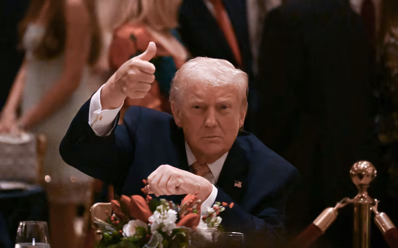 US President Donald Trump gives a thumbs up as he attends a Christmas dinner at his Mar-a-Lago resort in Palm Beach, Florida, on December 24, 2025. (Photo by ANDREW CABALLERO-REYNOLDS / AFP)