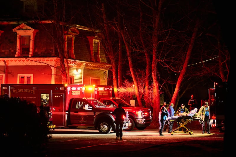 First responders with the Providence Fire Department maneuver an empty stretcher near the Barus & Holley building.