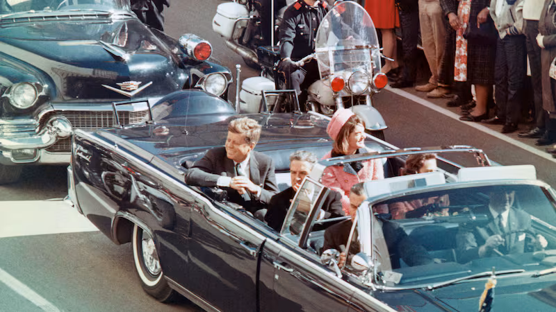 US President John F Kennedy, First Lady Jacqueline Kennedy, Texas Governor John Connally, and others smile at the crowds lining their motorcade route in Dallas, Texas, on November 22, 1963.
