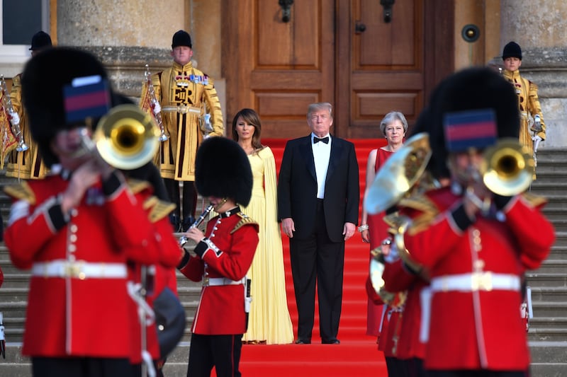 Britain’s Prime Minister Theresa May, (R) President Donald Trump (C) and Melania Trump (L) at Blenheim Palace, on July 12, 2018.
