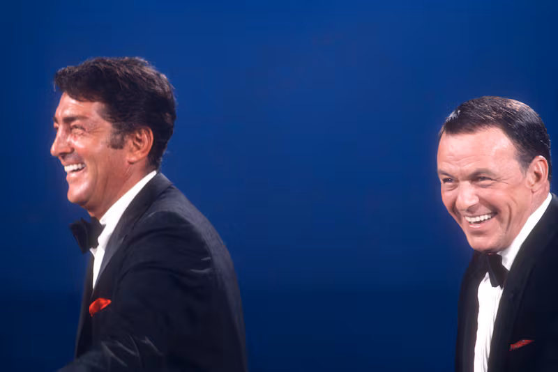 Dean Martin and Frank Sinatra sing on stage in 1967.