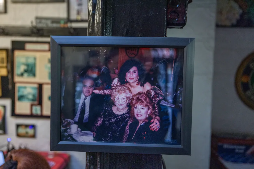 Framed photo of two men and two women in a celebratory setting.