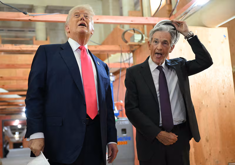 President Donald Trump speaks with Federal Reserve chair Jerome Powell (R) as he visits the Federal Reserve in Washington, DC, on July 24, 2025.