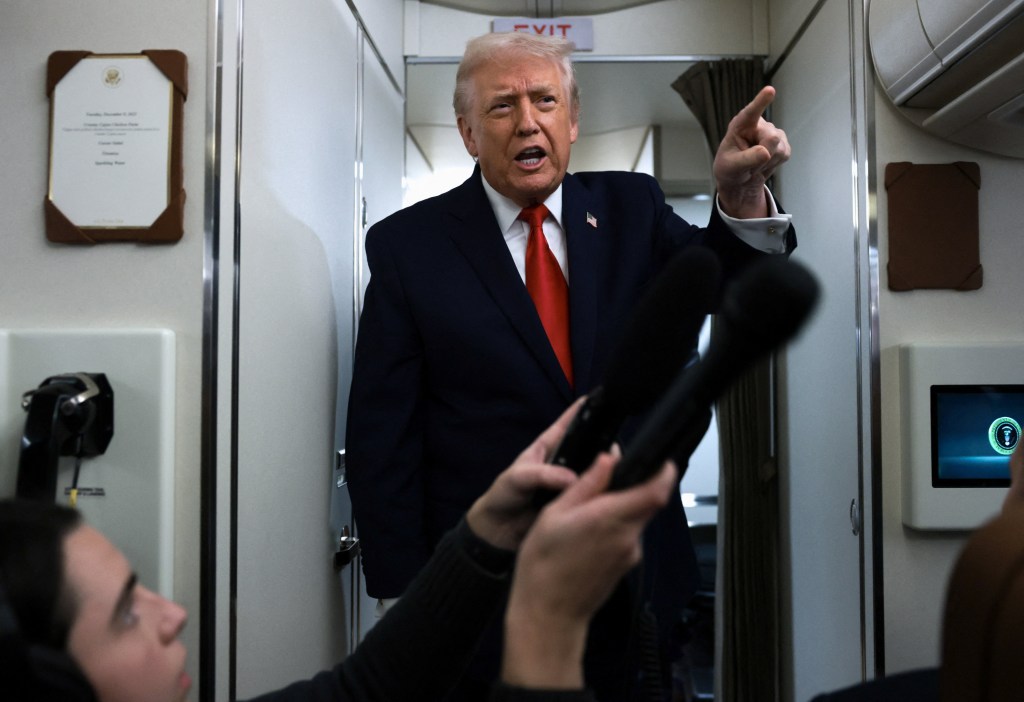 U.S. President Donald Trump points his finger as he speaks to reporters aboard Air Force One during travel to Pennsylvania from Joint Base Andrews, Maryland, U.S. December 9, 2025.