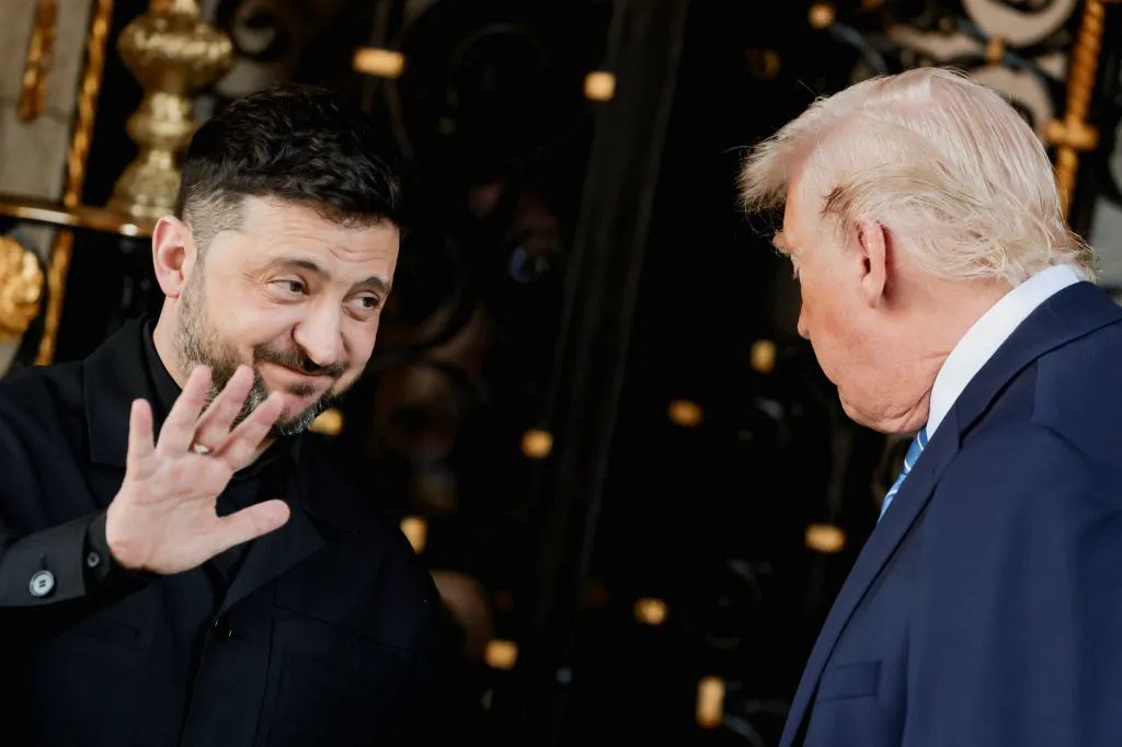 U.S. President Trump looking at Ukrainian President Zelenskiy, who is gesturing with his left hand.