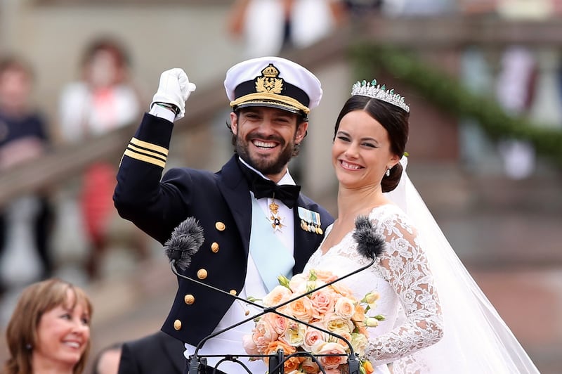Prince Carl Philip and Princess Sofia of salute the crowd on their wedding day in 2015.