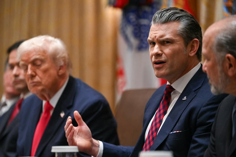 US Secretary of Defense Pete Hegseth (R) speaks alongside President Donald Trump (L)