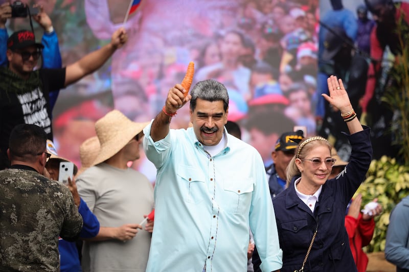 Venezuelan President Nicolas Maduro (center) is celebrated by participants at a rally marking the anniversary of a battle on the day Venezuelan opposition leader Machado was awarded the Nobel Peace Prize.