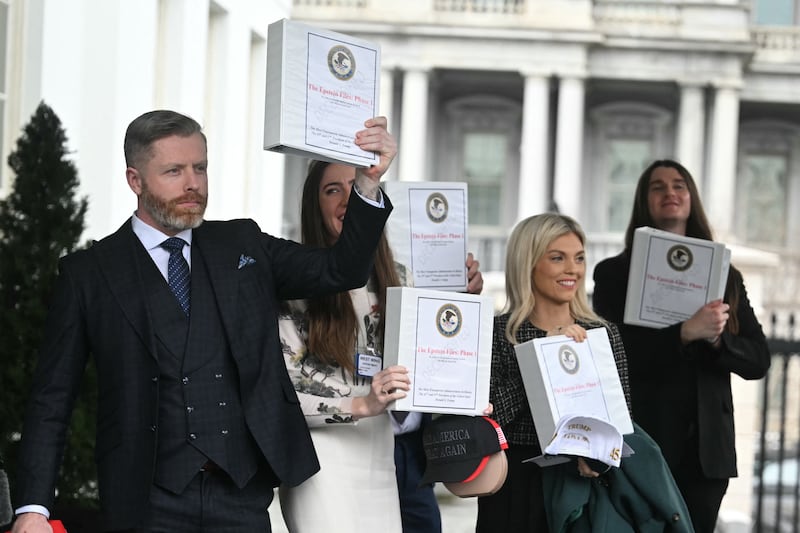 Political commentator Rogan O'Handley, aka DC Draino, TikToker Chaya Raichik, commentator Liz Wheeler and conservative activist Scott Presler carry binders bearing the seal of the US Justice Department reading