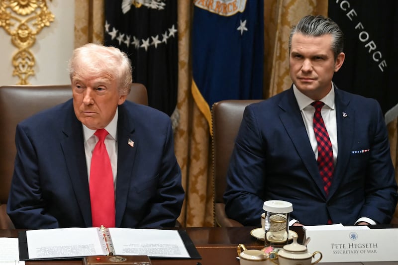 US President Donald Trump (L), alongside Secretary of Defense Pete Hegseth (R), holds a Cabinet Meeting in the Cabinet Room of the White House in Washington, DC on December 2, 2025. (Photo by ANDREW CABALLERO-REYNOLDS / AFP via Getty Images)