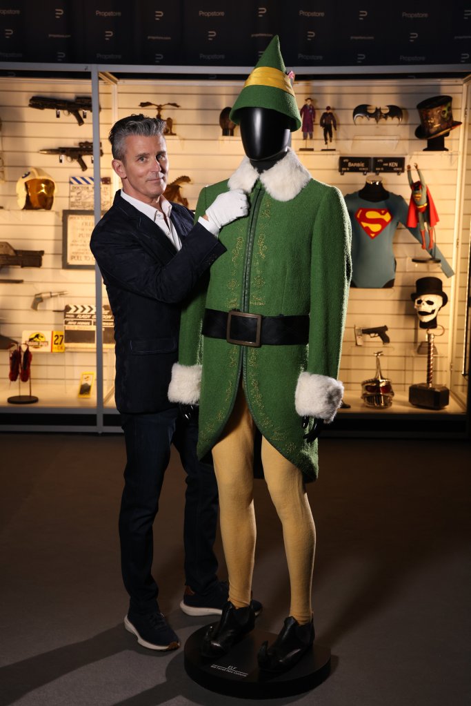 A man in a suit adjusts the