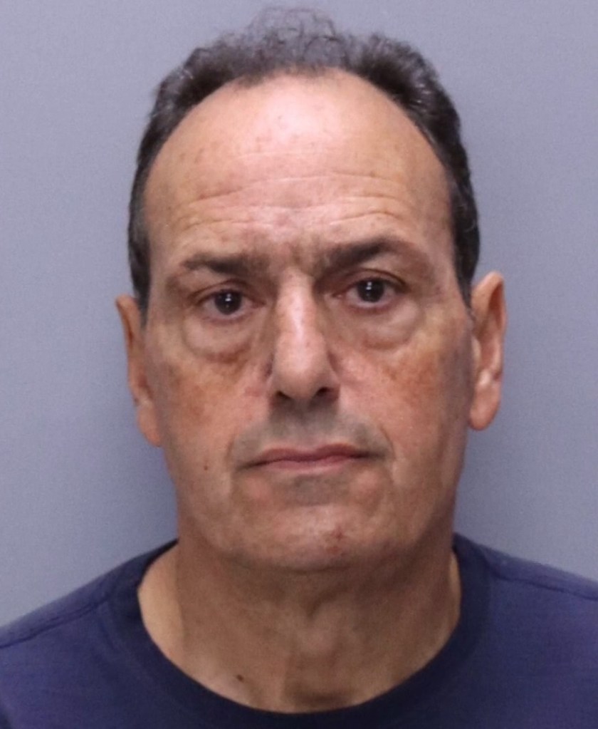 Mugshot of a man with dark hair and a serious expression.