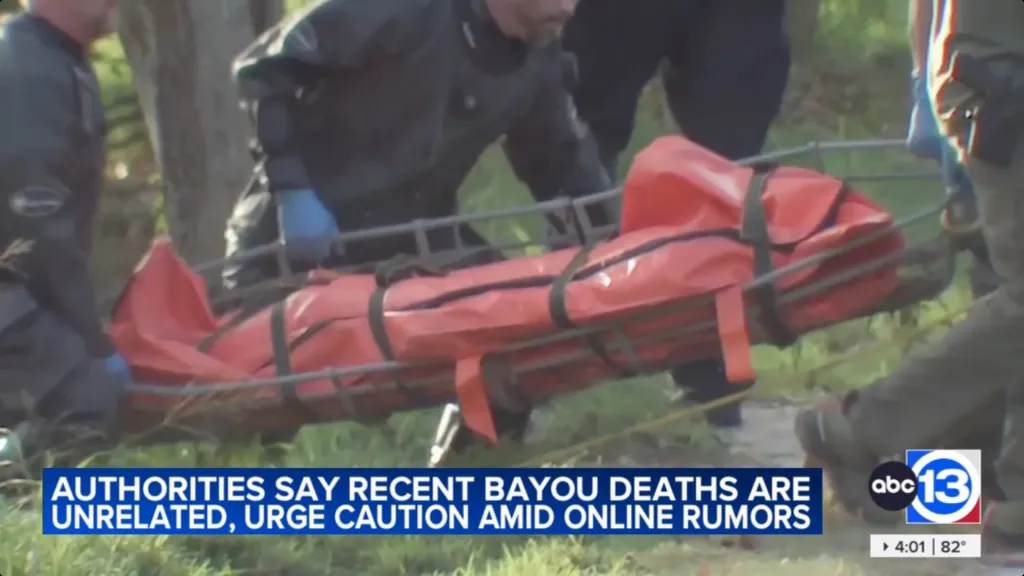 Emergency responders carrying a body wrapped in an orange bag on a stretcher.