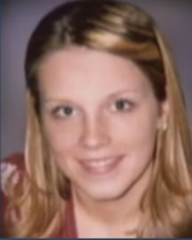 Smiling woman with light brown hair.