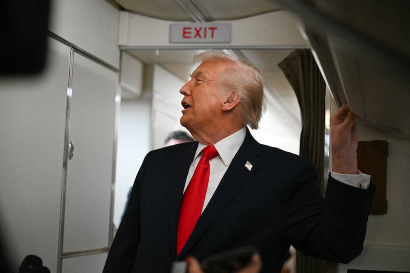 US President Donald Trump speaks to the media aboard Air Force One on December 9, 2025, en route to deliver remarks in Pennsylvania. (Photo by ANDREW CABALLERO-REYNOLDS / AFP via Getty Images)