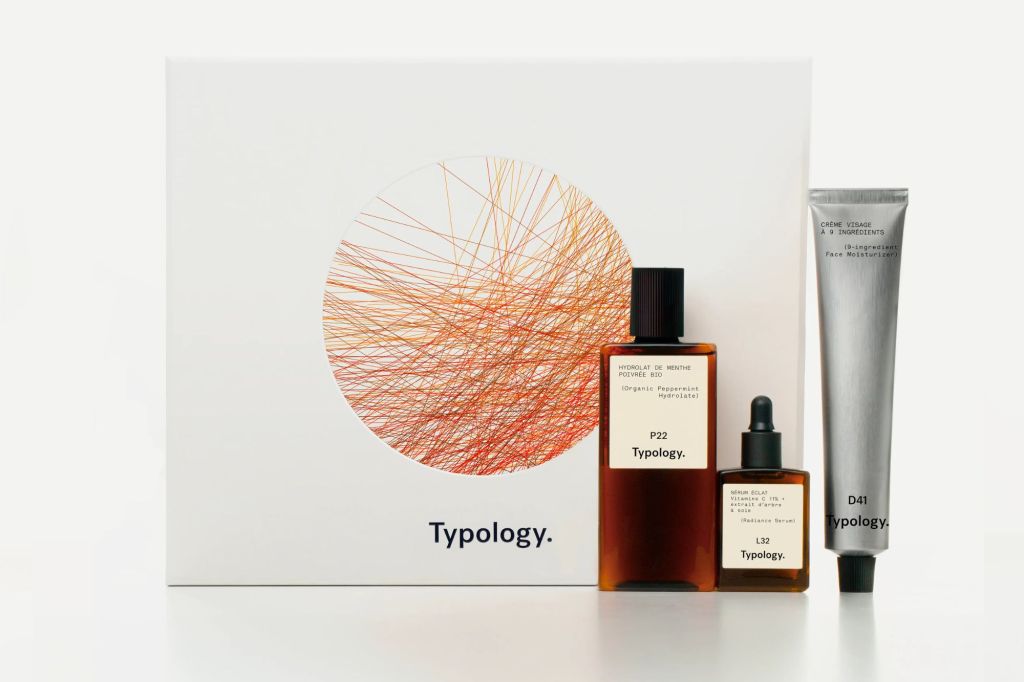 A box with three Typology skincare products beside it.
