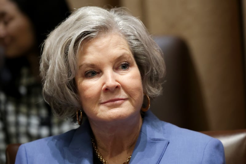 Chief of Staff Susie Wiles listens as President Donald Trump speaks during an Ambassador Meeting in the Cabinet Room of the White House.