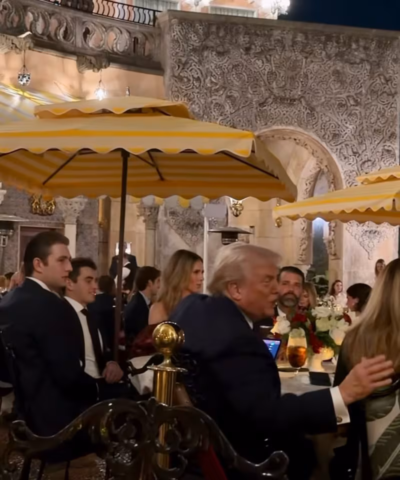 Barron Trump is spotted in the background of footage taken at the Mar-a-Lago Christmas Day dinner.