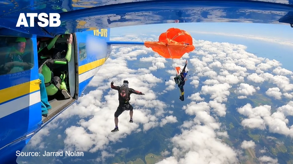 A skydiver was left dangling 15,000 feet in the air after his parachute caught on the plane’s trail.