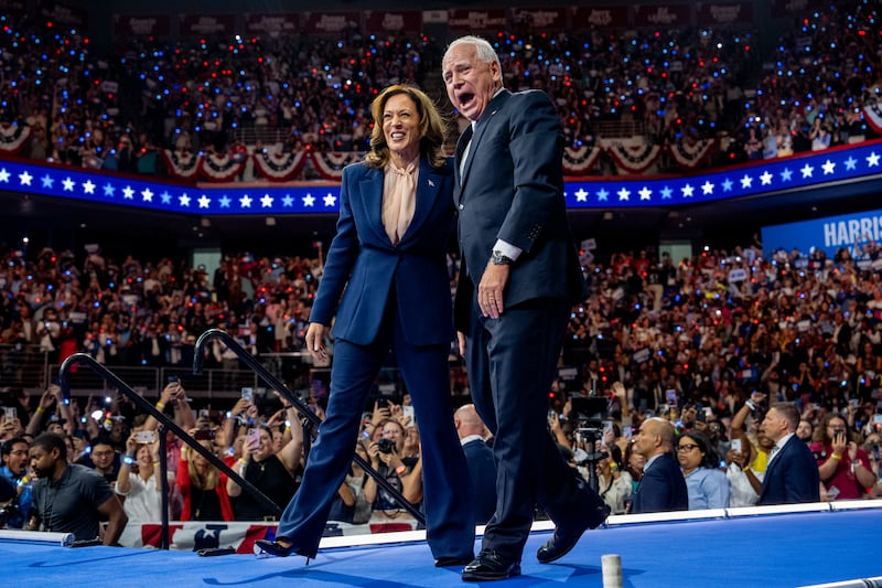 Kamala Harris and Tim Walz walk out on stage together during a campaign event on August 6, 2024 in Philadelphia, Pennsylvania.