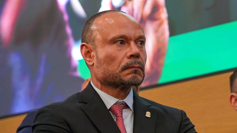 Assistant Director Dan Bongino watches a news conference