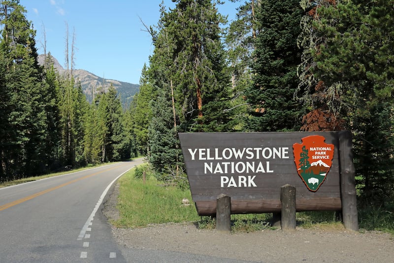 Entrance sign along U.S. Highway 212 at the northeast entrance into Yellowstone National Park in Wyoming, The northeast entrance to Yellowstone National Park is on US Highway 212 a few miles west of Cooke City Montana as one crosses into Wyoming. (Photo by: Education Images/Universal Images Group via Getty Images)