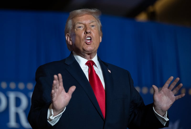 US President Donald Trump sings upon his arrival to deliver remarks on the economy at Mount Airy Casino Resort in Mount Pocono, Pennsylvania, on December 9, 2025. (Photo by ANDREW CABALLERO-REYNOLDS / AFP via Getty Images)