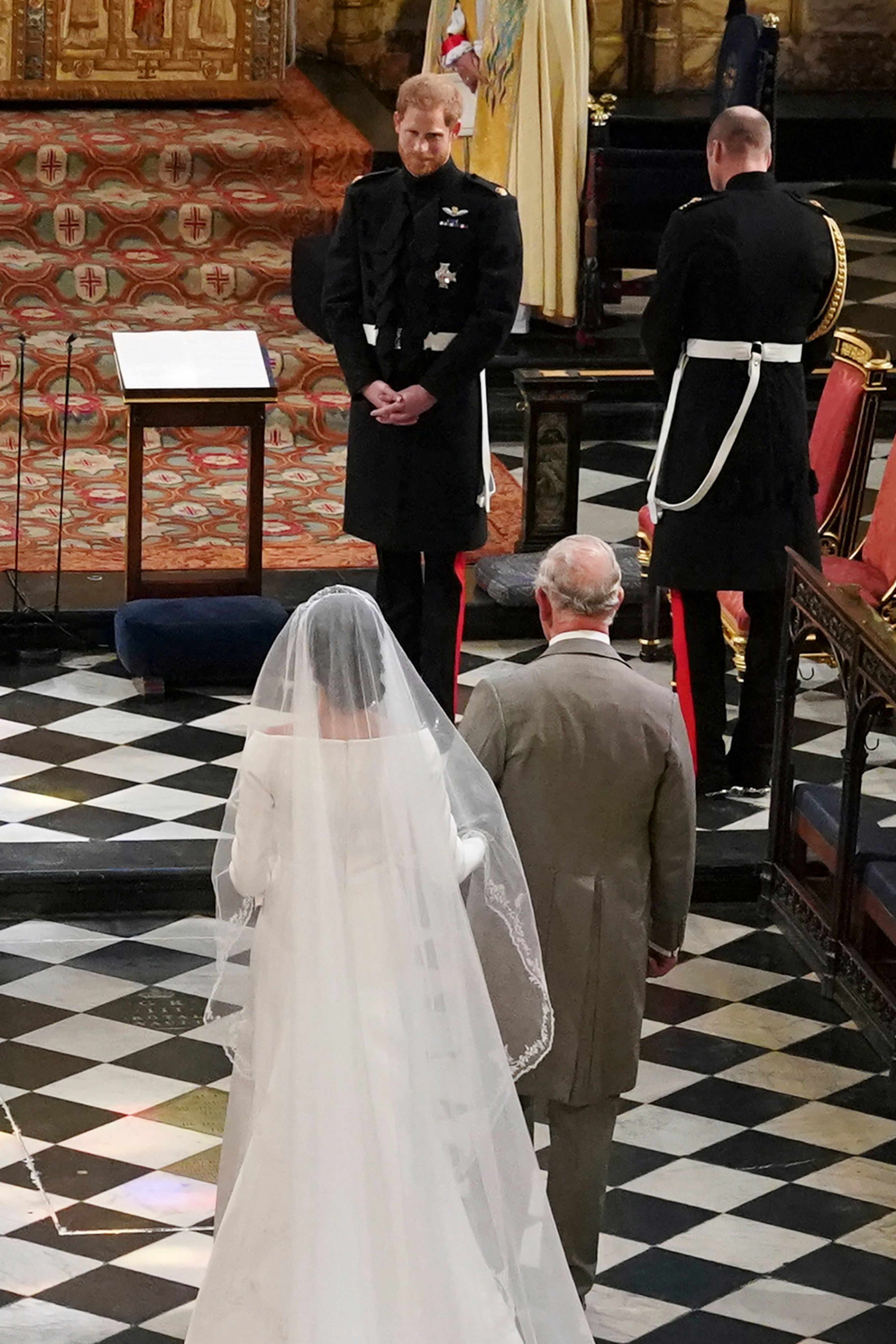 Meghan Markle walking down the aisle with Prince Charles at her wedding to Prince Harry.