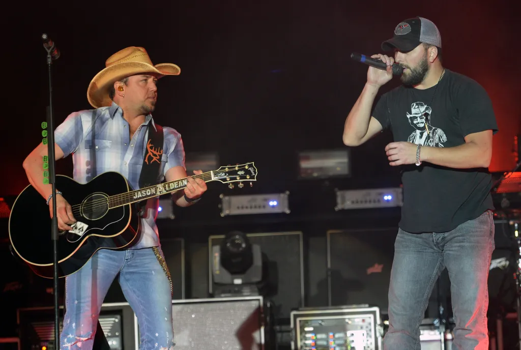 Jason Aldean and Tyler Farr performing on stage.