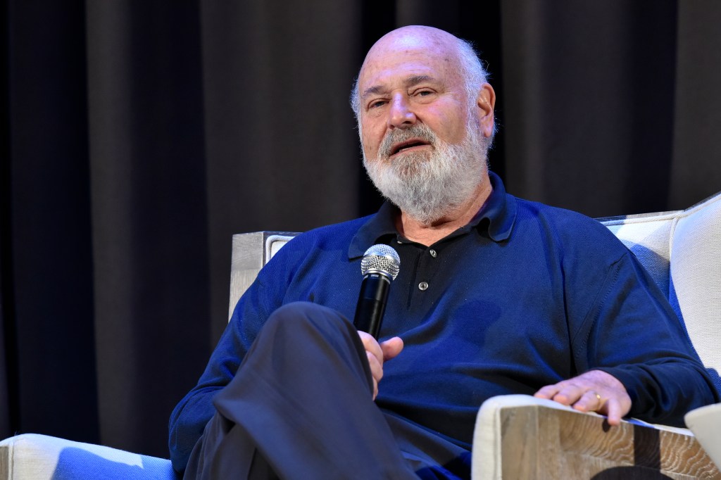 Rob Reiner sitting on stage and speaking into a microphone.