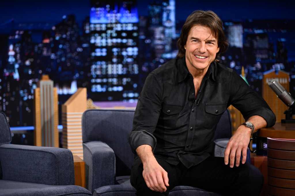 Tom Cruise smiling during an interview on The Tonight Show.