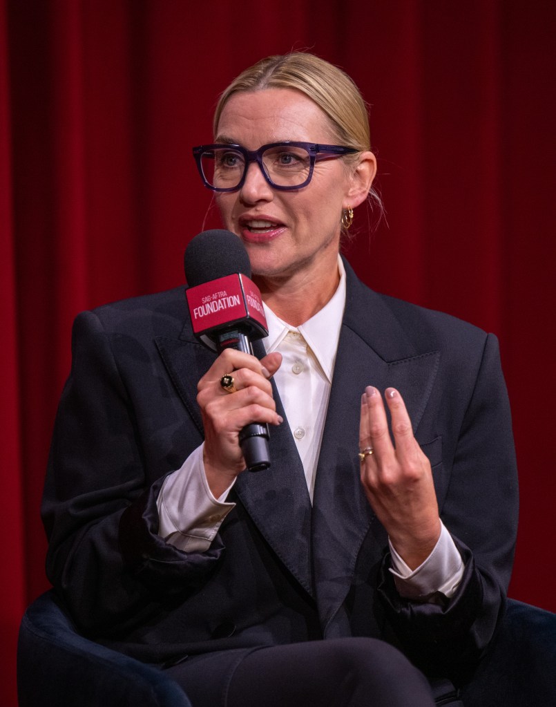 Kate Winslet speaking into a microphone.