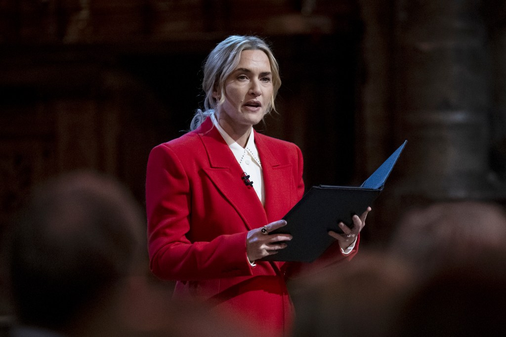 Kate Winslet delivering a reading at a carol service.