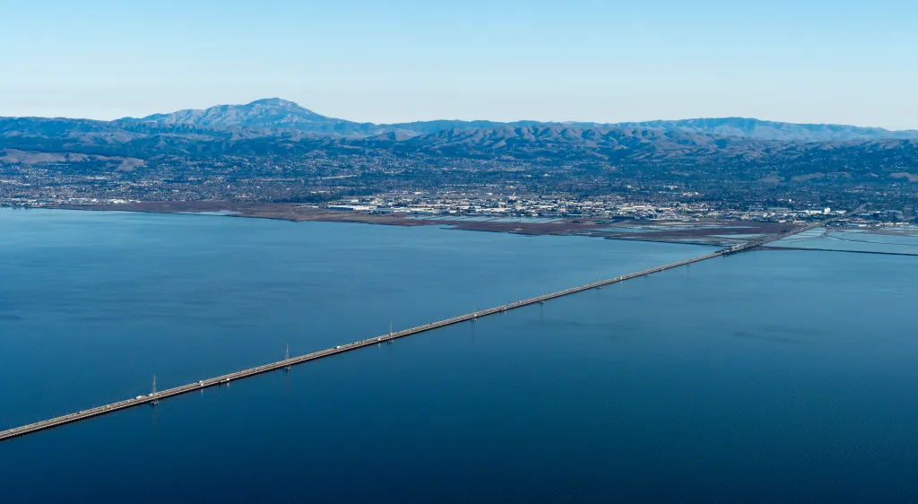 Aerial view of the San Mateo Bridge spanning the San Francisco Bay with Mt. Diablo in the background.