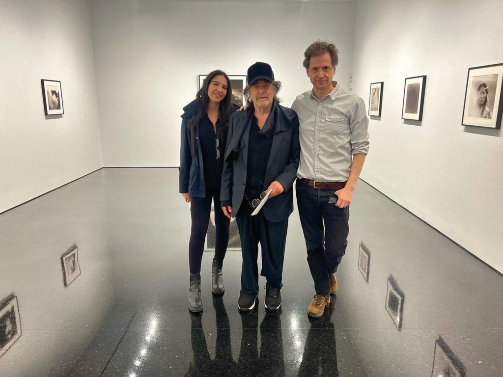 Al Pacino, Noor Alfallah, and a man posing in an art gallery.