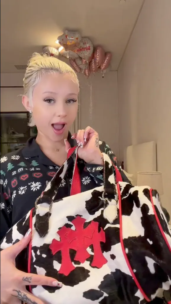 Alabama Barker shows off a $15K Chrome Hearts duffle bag.