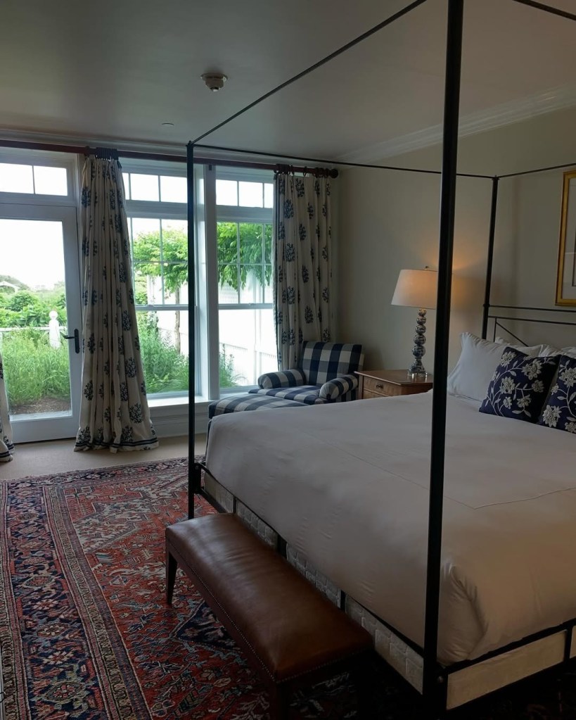 Bedroom at Ocean House, Rhode Island, with a four-poster bed and patterned rug.