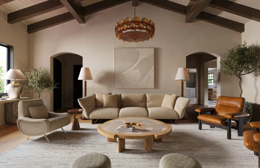 A living room with a beige sofa, two armchairs, a round coffee table, and an amber chandelier.