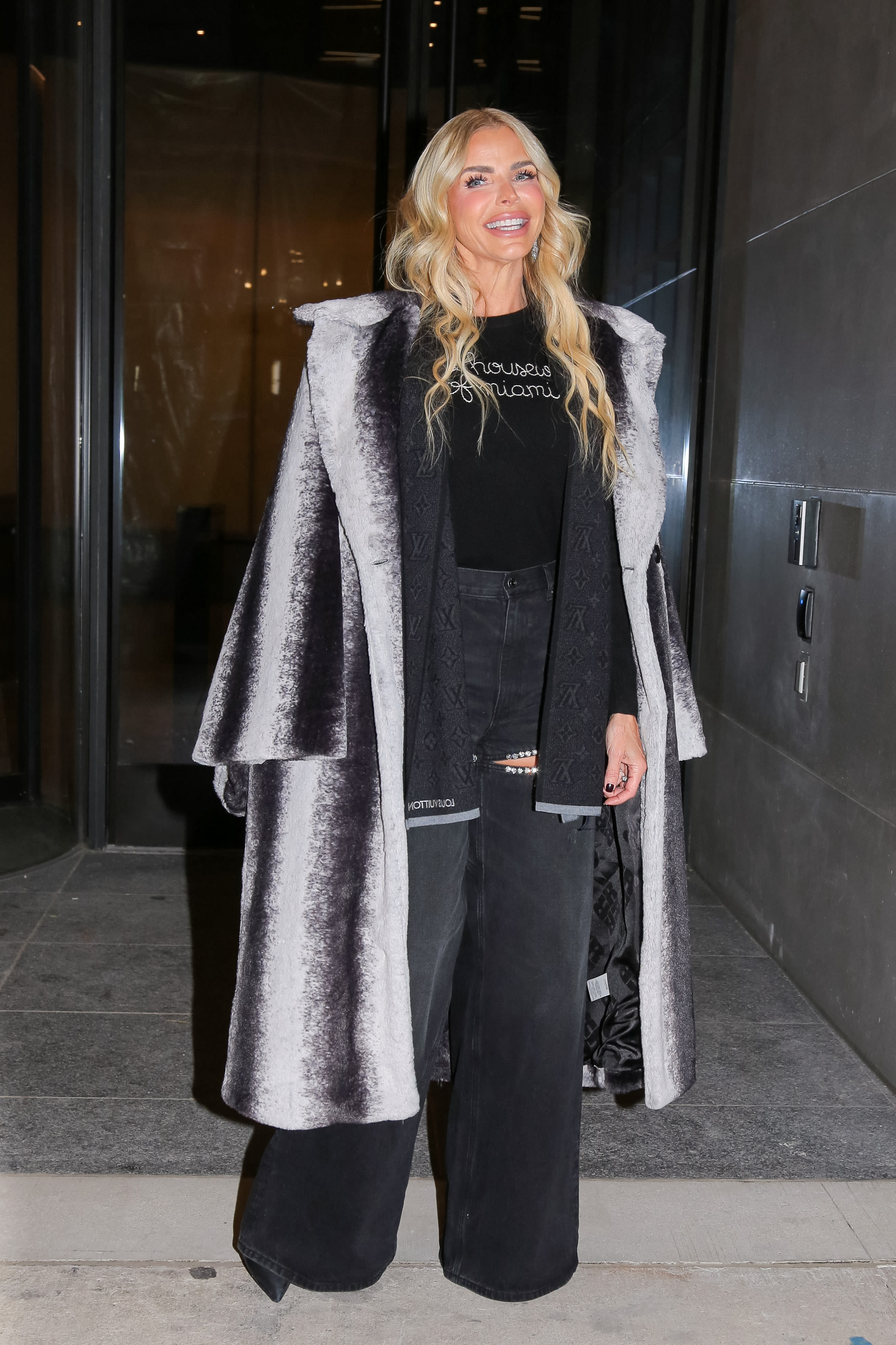 Alexia Nepola wearing a Louis Vuitton coat with a black top and pants.