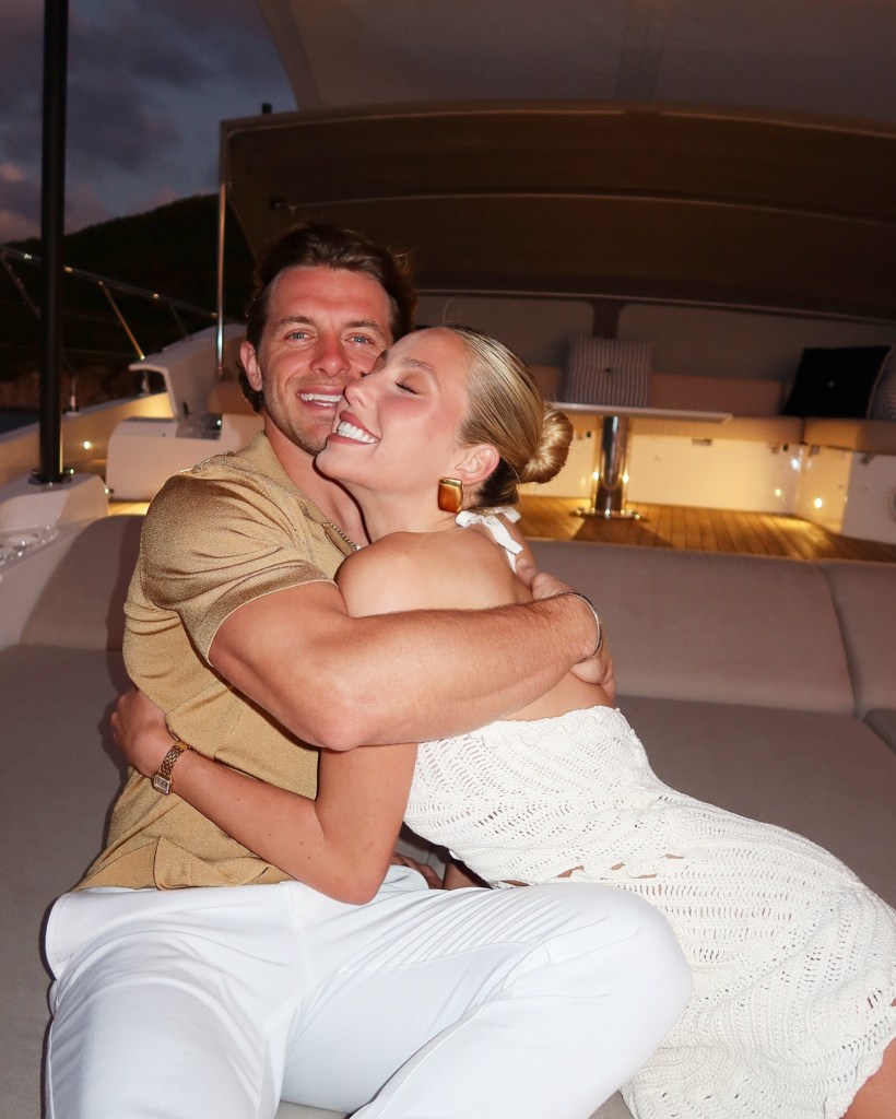 Alix Earle and Braxton Berrios hugging on a yacht.