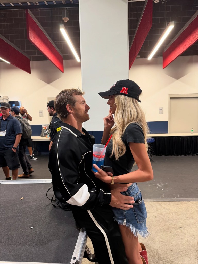 Alix Earle and Braxton Berrios looking at each other, with Berrios' arm around Earle's waist.