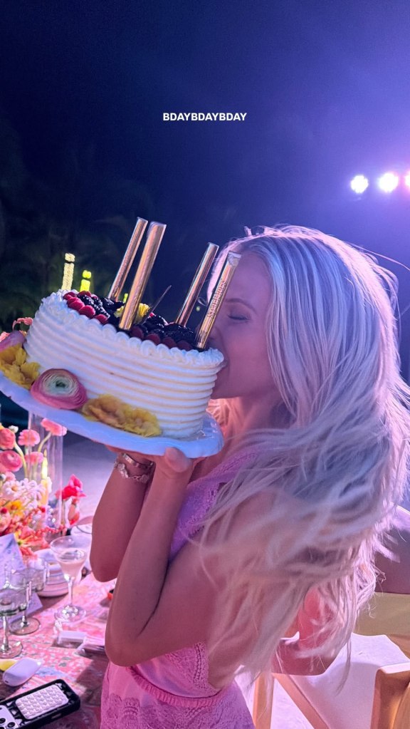 Alix Earle biting into her birthday cake.