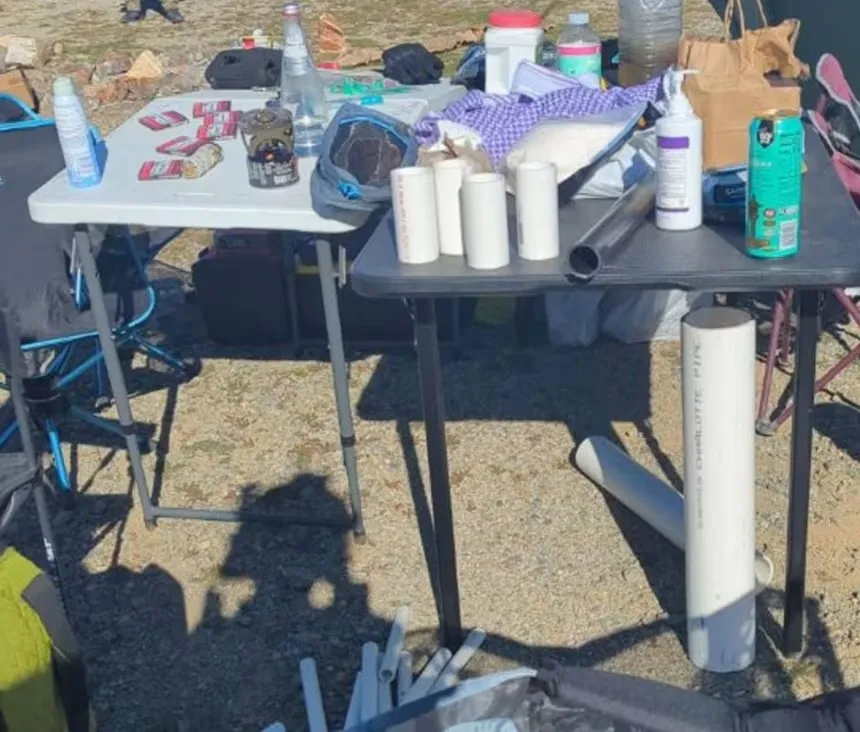 Evidence presented by the US Justice Department, including PVC pipes, bottles, and a burner on tables.