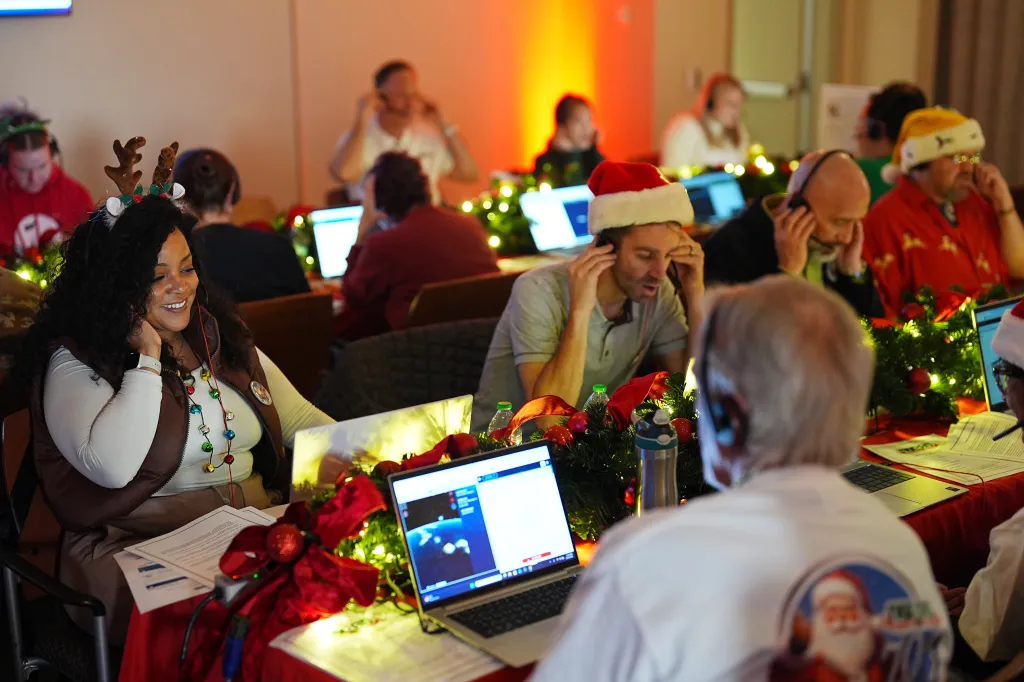 Amber Akisawya and other volunteers taking calls during NORAD Santa tracking at Peterson Space Force Base.